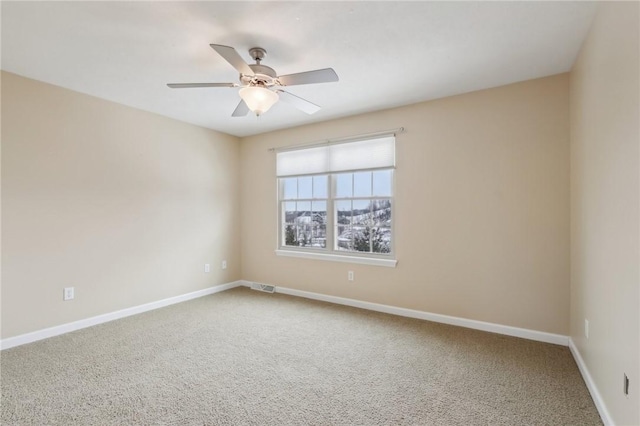 carpeted empty room featuring ceiling fan