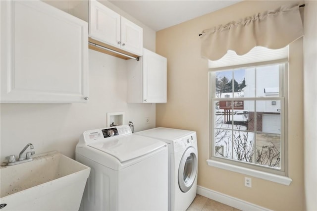 laundry room featuring cabinets, sink, washer and dryer, and light tile patterned floors