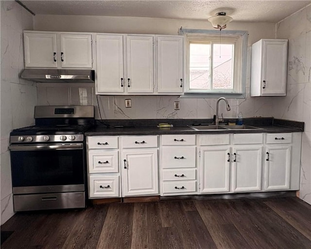 kitchen with dark hardwood / wood-style flooring, a textured ceiling, sink, stainless steel range oven, and white cabinetry