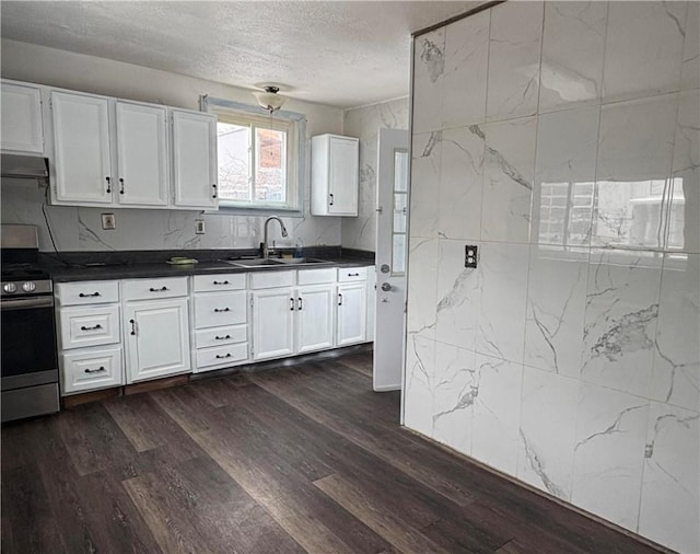 kitchen with white cabinetry, electric range, sink, a textured ceiling, and exhaust hood