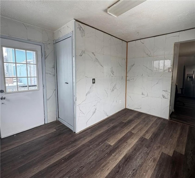 interior space featuring dark hardwood / wood-style flooring and a textured ceiling