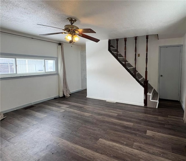 unfurnished room featuring ceiling fan, dark hardwood / wood-style flooring, and a textured ceiling