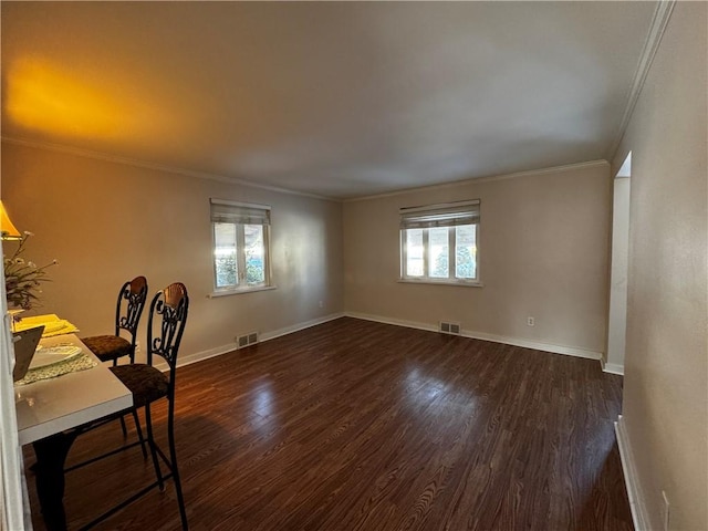 unfurnished office with crown molding, dark hardwood / wood-style floors, and a healthy amount of sunlight