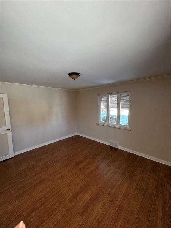 unfurnished room with crown molding and dark hardwood / wood-style floors