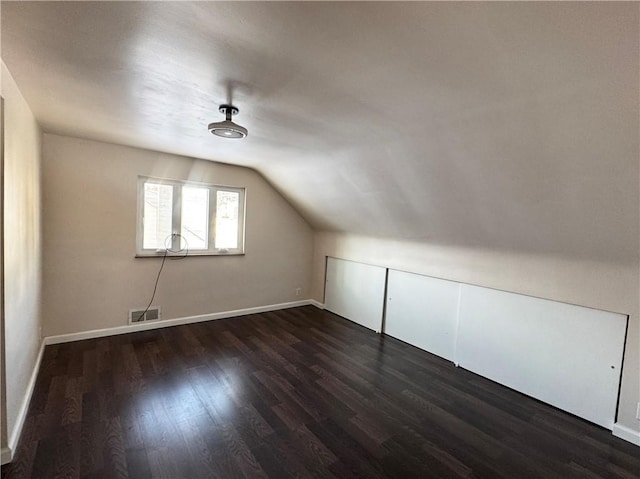 additional living space with dark hardwood / wood-style flooring and lofted ceiling