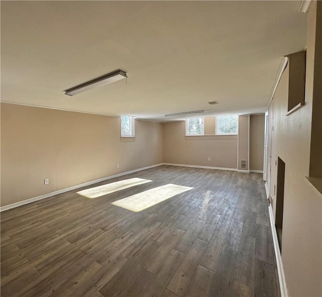 basement with dark hardwood / wood-style flooring