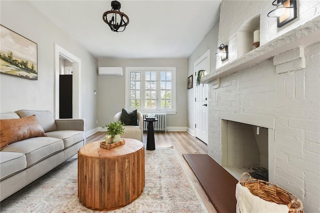 living room with light wood-type flooring, an AC wall unit, a fireplace, and radiator