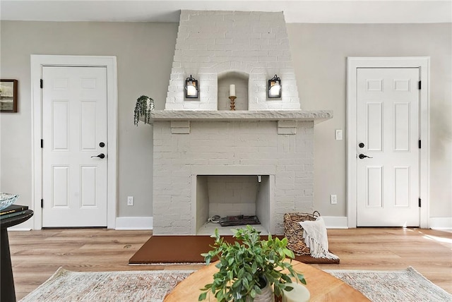 living room with a fireplace and wood-type flooring