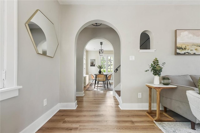 hallway with light hardwood / wood-style floors