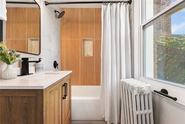 bathroom featuring vanity, radiator, and shower / tub combo