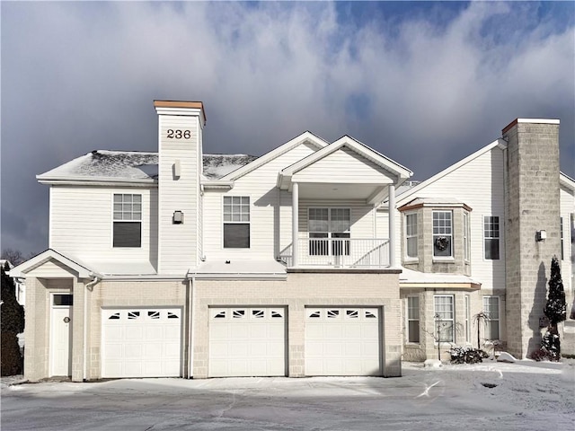 view of front facade with a balcony and a garage