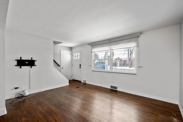 interior space featuring wood finished floors, visible vents, and baseboards