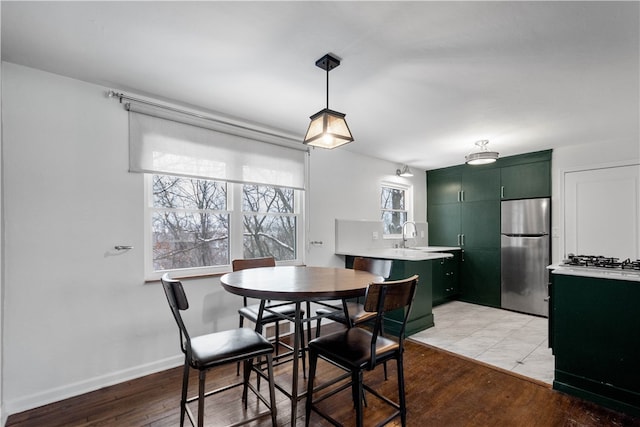 dining room with light hardwood / wood-style floors and sink