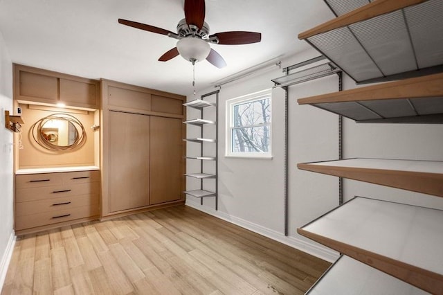 unfurnished bedroom featuring ceiling fan, light wood-type flooring, and a closet