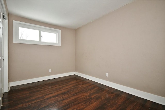 spare room with dark hardwood / wood-style floors