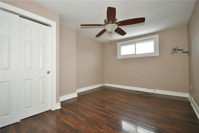 unfurnished bedroom with dark hardwood / wood-style flooring, ceiling fan, and a closet