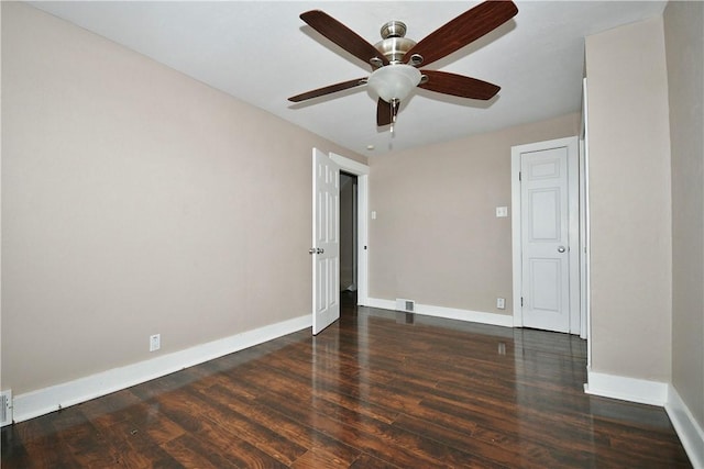 spare room featuring ceiling fan and dark hardwood / wood-style floors