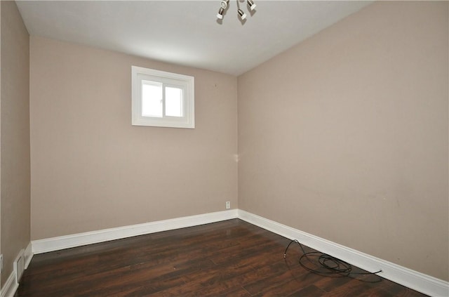 spare room with dark wood-type flooring