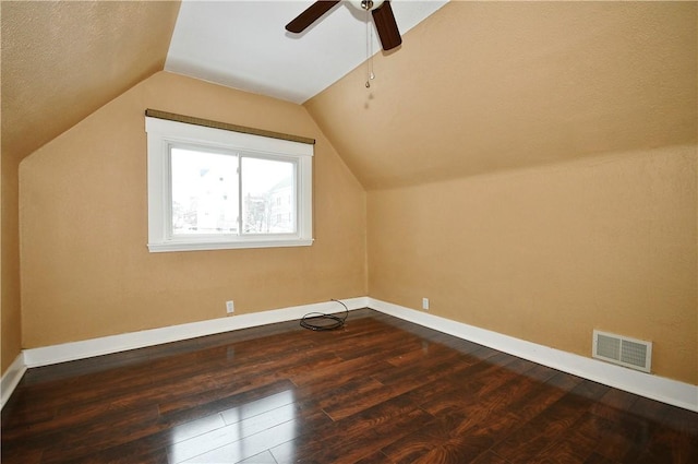 bonus room featuring dark hardwood / wood-style flooring, vaulted ceiling, and ceiling fan