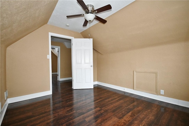 bonus room featuring a textured ceiling, ceiling fan, dark hardwood / wood-style floors, and lofted ceiling