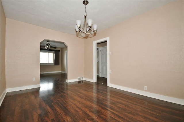 spare room featuring ceiling fan with notable chandelier and dark hardwood / wood-style floors