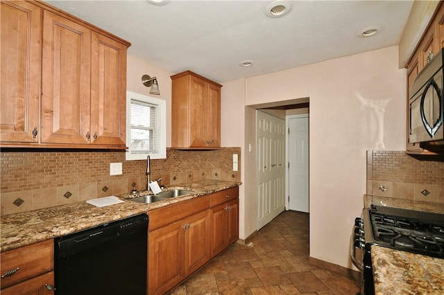 kitchen with black appliances, decorative backsplash, light stone countertops, and sink