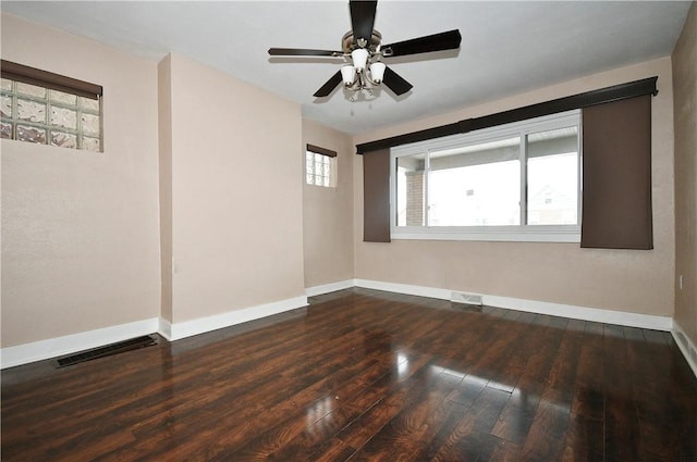 empty room featuring ceiling fan and dark wood-type flooring