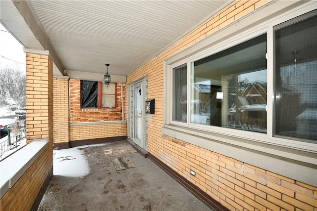 snow covered property featuring covered porch