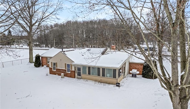 view of snow covered rear of property