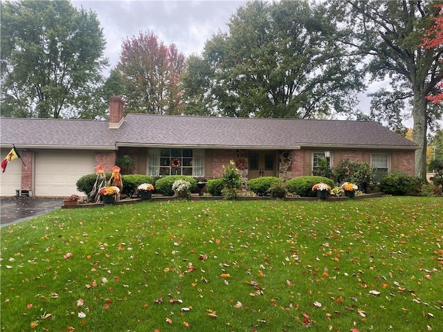 ranch-style home with a garage and a front yard