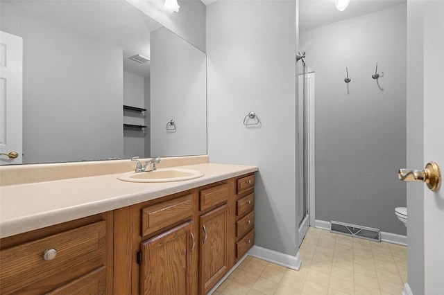 bathroom with vanity, toilet, and walk in shower