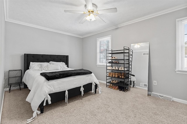 carpeted bedroom featuring ceiling fan, crown molding, and a textured ceiling