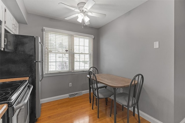 dining room featuring light hardwood / wood-style floors and ceiling fan