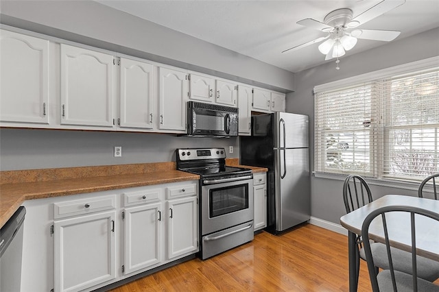 kitchen featuring white cabinets, light hardwood / wood-style flooring, ceiling fan, appliances with stainless steel finishes, and plenty of natural light