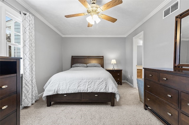 carpeted bedroom featuring connected bathroom, ceiling fan, a textured ceiling, and ornamental molding