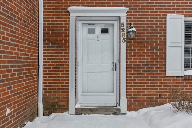 view of snow covered property entrance