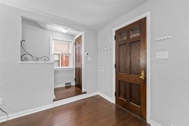 entryway with dark hardwood / wood-style flooring