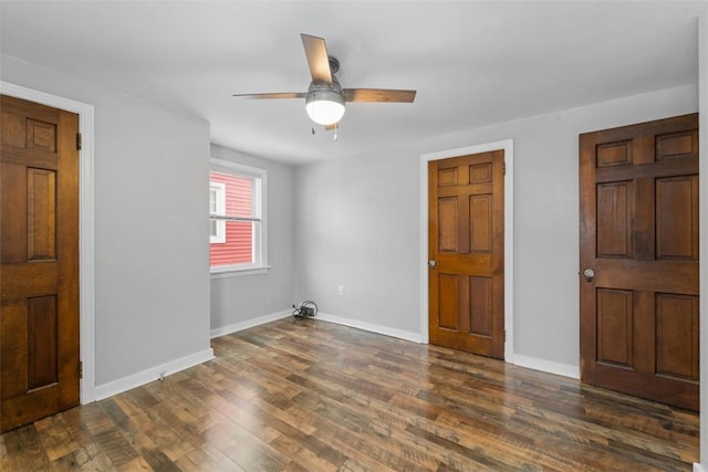 foyer featuring ceiling fan and dark wood-type flooring