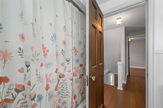 bathroom featuring a shower with shower curtain and hardwood / wood-style flooring