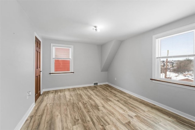 bonus room with light wood-type flooring