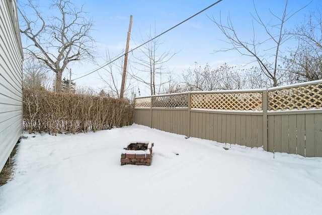 snowy yard featuring a fire pit