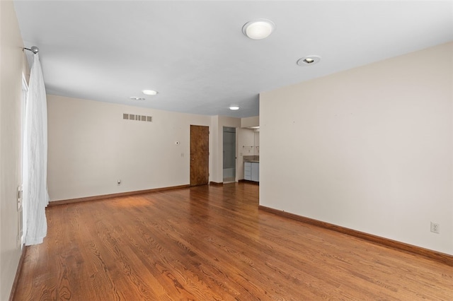 unfurnished room with hardwood / wood-style floors