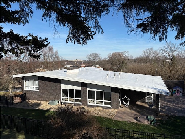 rear view of house with a yard and a patio