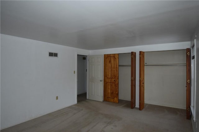 unfurnished bedroom with light colored carpet