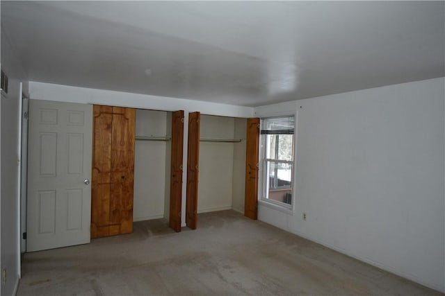 unfurnished bedroom with light carpet