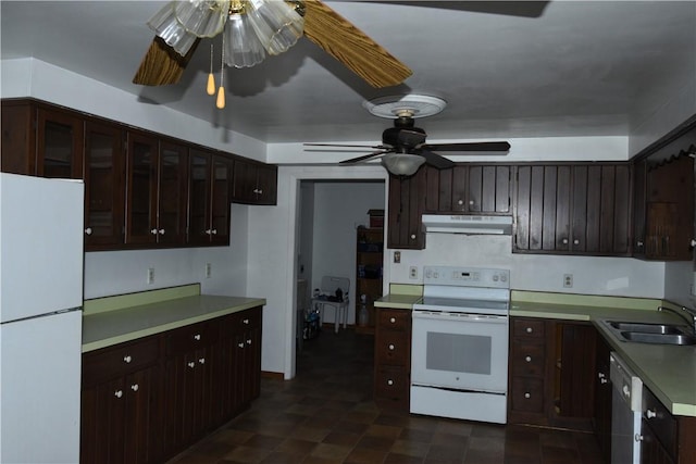 kitchen with ceiling fan, dark brown cabinetry, white appliances, and sink