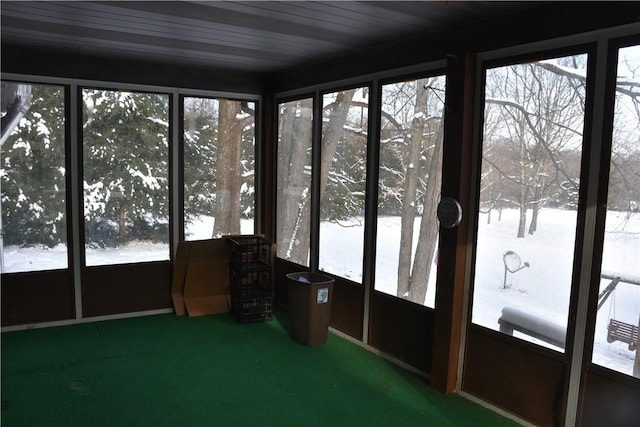 unfurnished sunroom with wood ceiling