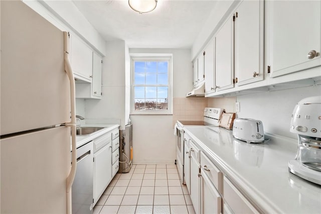 kitchen featuring white cabinetry, sink, white appliances, and light tile patterned flooring