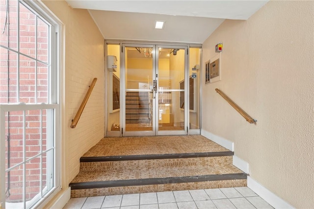 stairway featuring tile patterned flooring