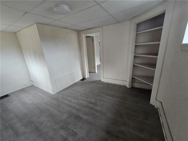 carpeted spare room with a paneled ceiling